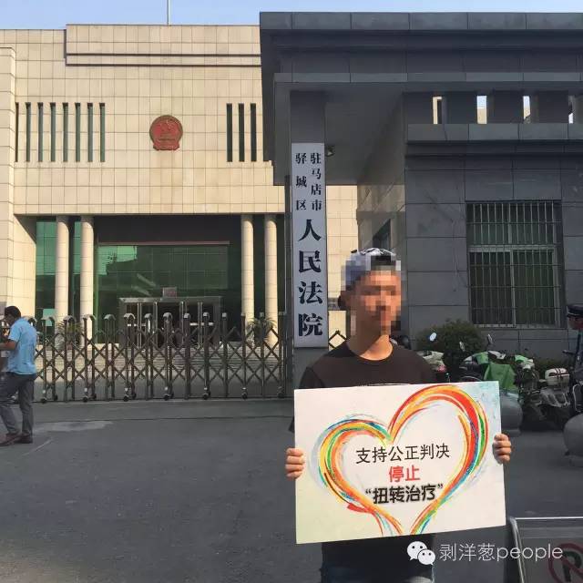 同性之间:同性恋男子“被强制治疗”19天 常做噩梦 2016年9月21日,志愿者在驻马店驿城区人民法院门口举牌支持余虎。受访者供图。