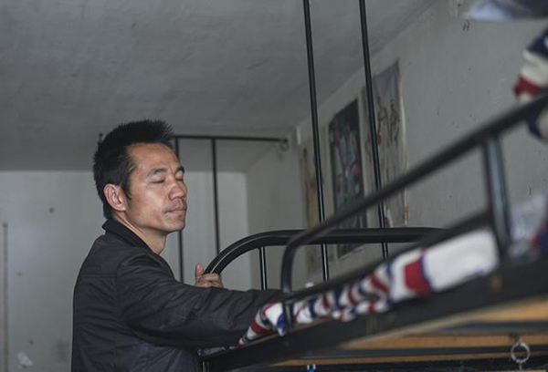 杨德富抚摸杨高飞的床铺。
