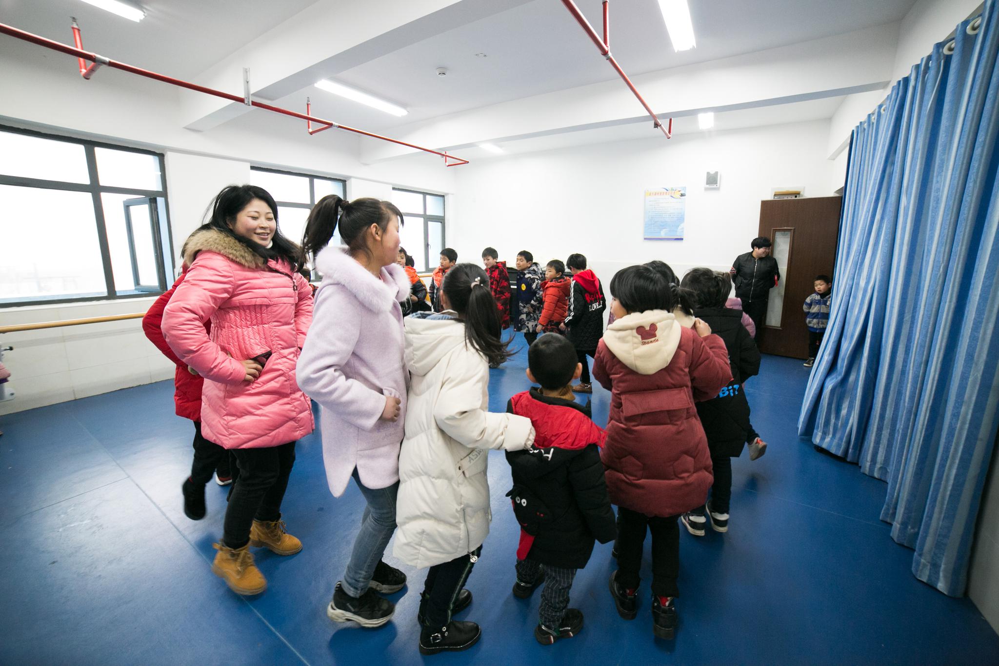 1月9日,在贵州毕节市大方县儿童福利院内,卢小卜在指导孩子们上网.