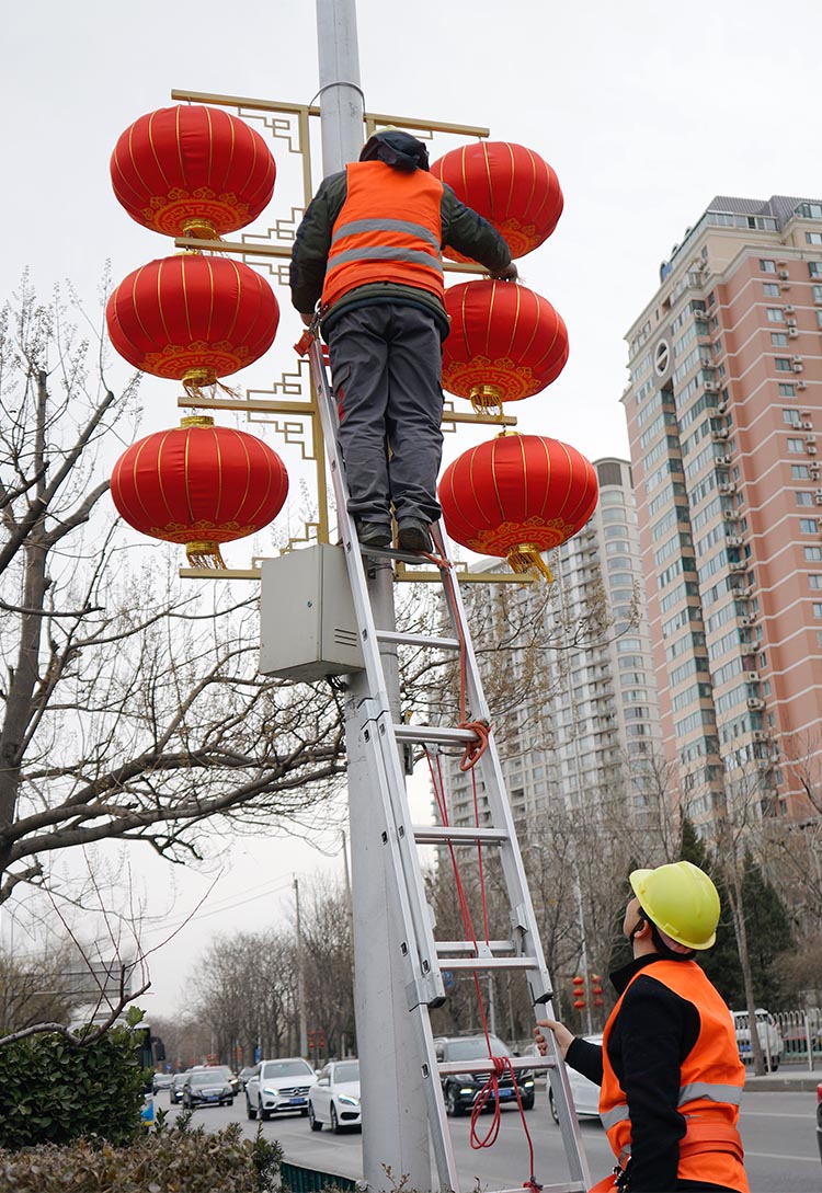 朝阳公园南路,工人为路灯加装红灯笼.高挂喜庆红灯笼.