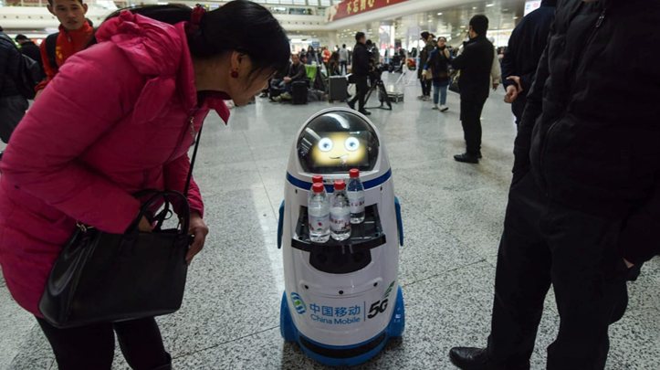 春运第一天，浙江杭州东站有5G机器人为乘客提供免费饮用水 图源：CNN