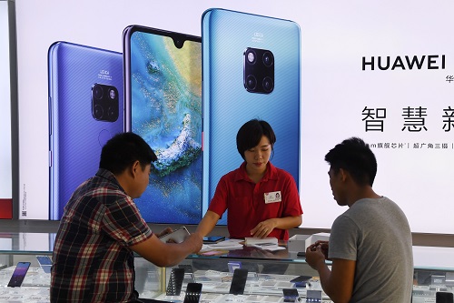 12月8日,顾客在海南三亚的华为门店选购手机。(法新社)