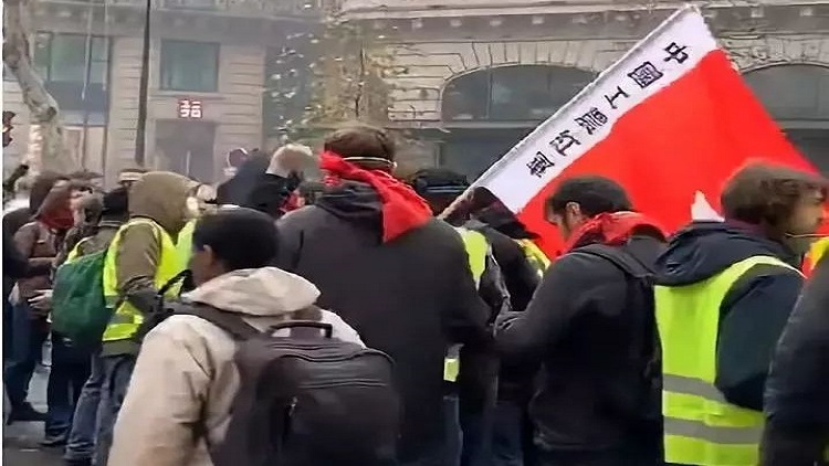 ▲在荟萃于奥斯曼大街的一群示威者中,有人打出”中国工农红军“旗帜。图/欧洲时报微博视频截图