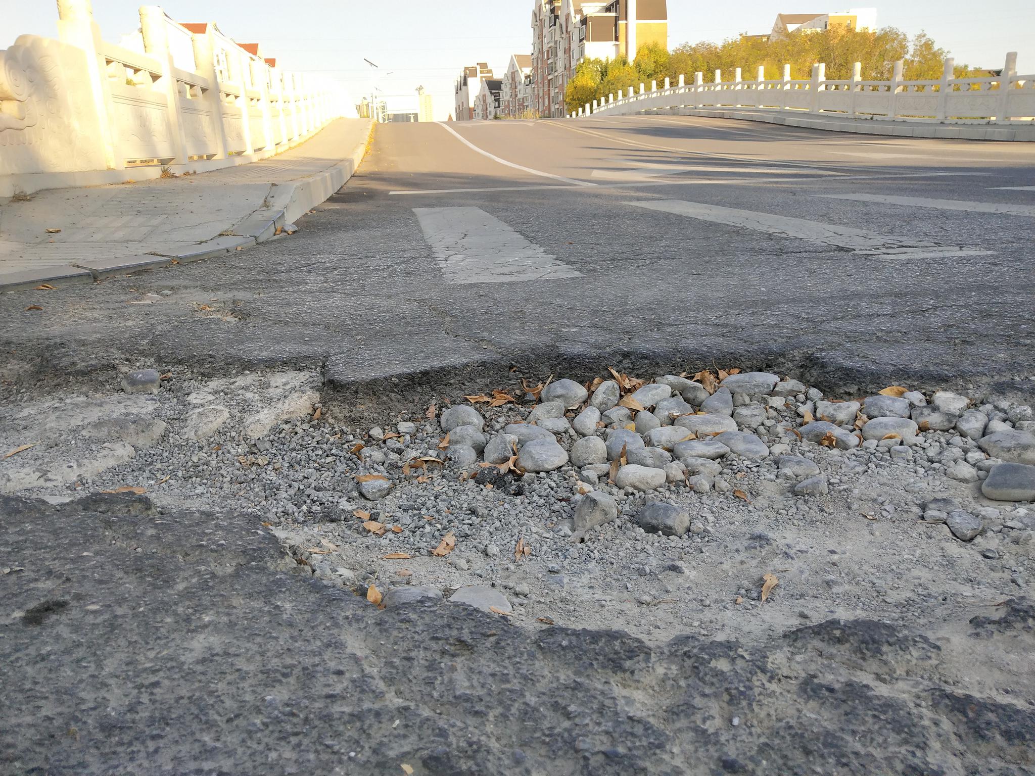 沂河路拱形桥上路面破损,让过路司机措手不及
