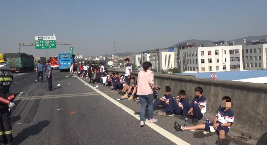 广东:广东载秋游大巴车高速追尾 1人死亡15人受伤 事发后,受伤学生下车等待救援。广州消防供图