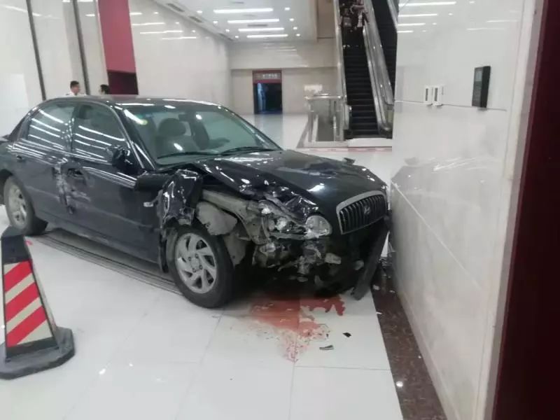 南宁国际会展中心停车场一小车失控撞墙车头被撞得稀巴烂地上一摊血