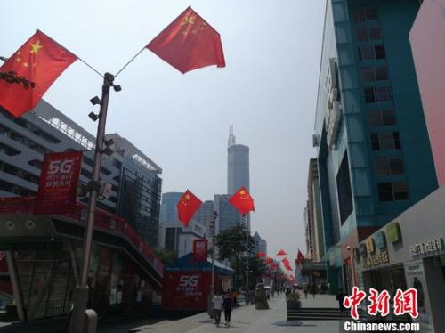 香港人看国庆阅兵 深圳华强北五星红旗迎风飘扬。程景伟 摄